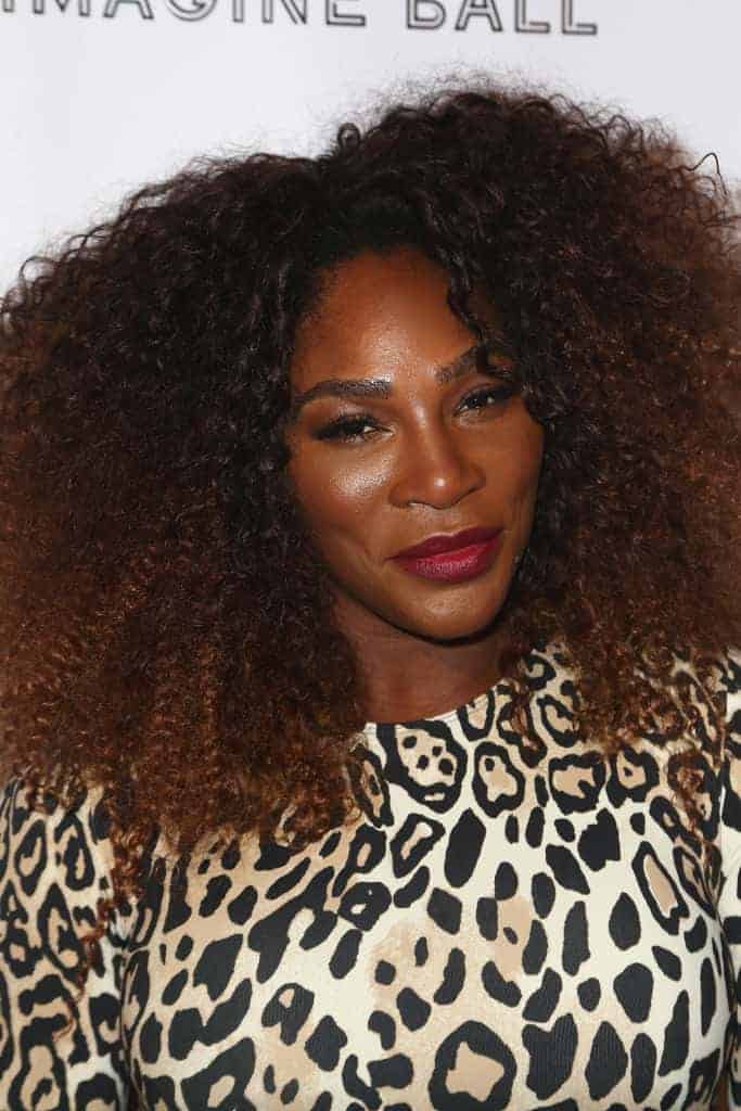 A Close up picture of Serena Williams wearing a cheetah print dress.