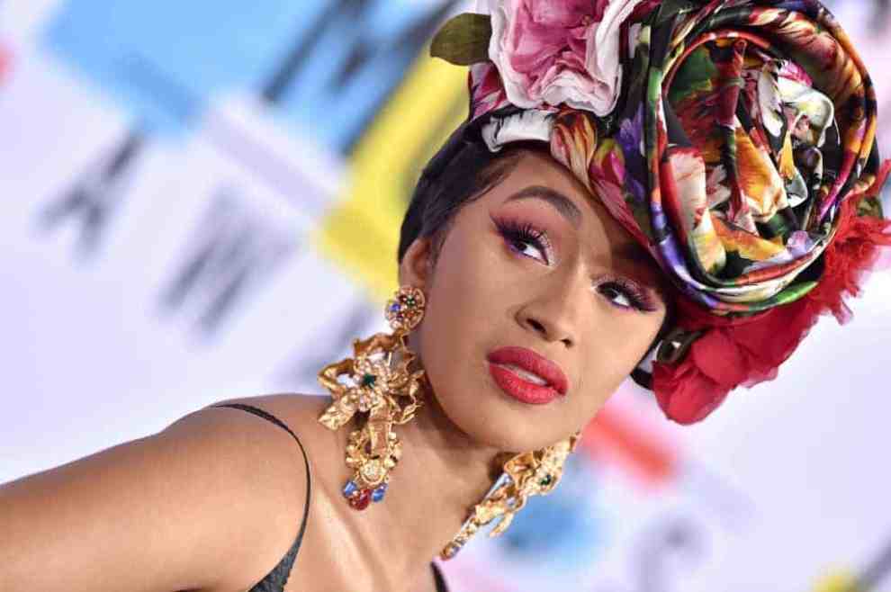 Cardi B attends the 2018 AMAs in flower print hat