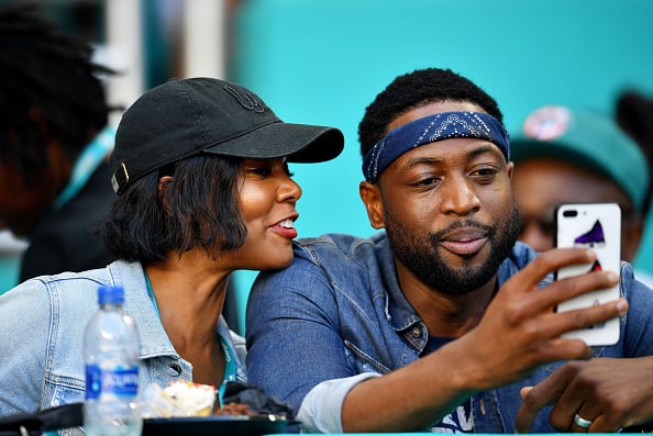 Dwyane Wade of the Miami Heat and wife and actress Gabrielle Union attend the game between the Miami Dolphins and Chicago Bears at Hard Rock Stadium on October 14