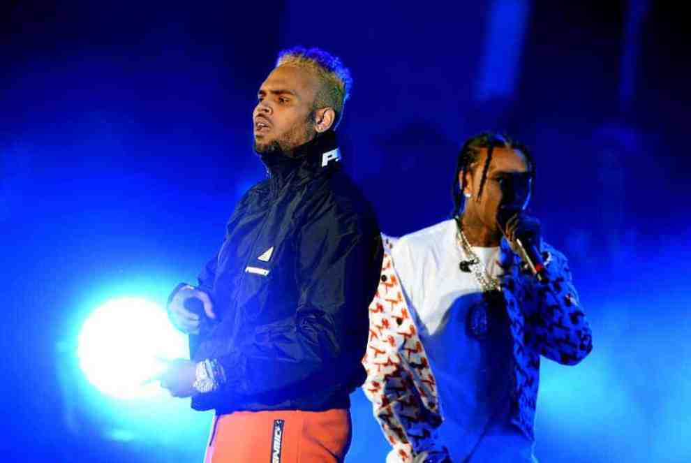 Chris Brown (L) and Tyga perform onstage during 'We Can Survive
