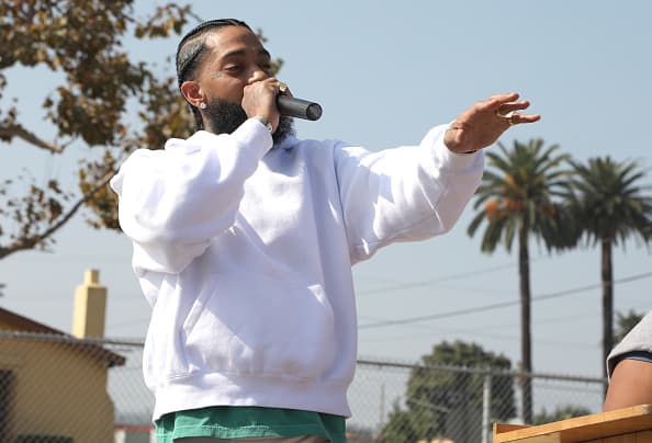 Nipsey Hussle speaks to kids at the Nipsey Hussle x PUMA Hoops Basketball Court Refurbishment Reveal Event on October 22