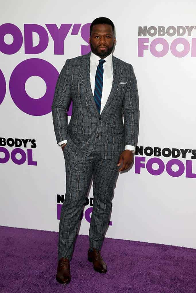 50 Cent wearing a grey suit