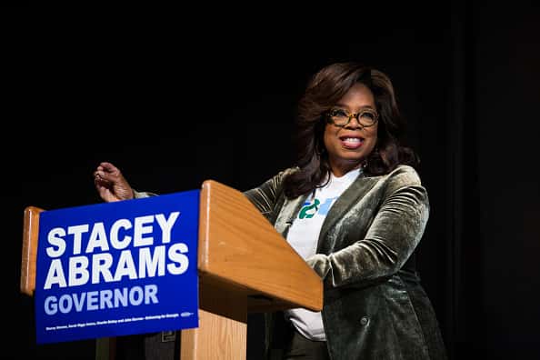 Oprah speaking on stage behind podium for Stacey Abrams for Govenor