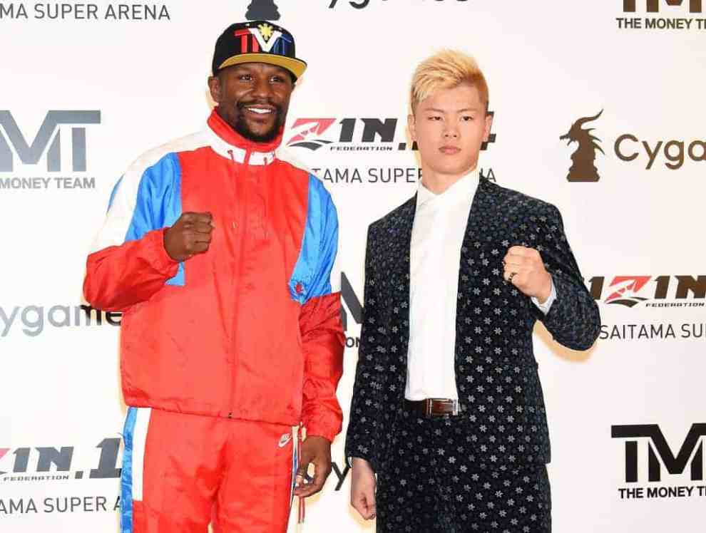 Floyd Mayweather and Tenshin Nasukawa standing next to each other wearing multiple colors