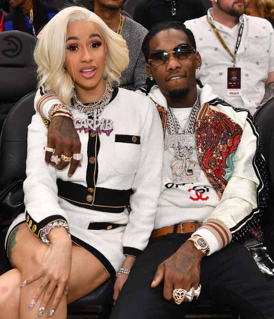 Cardi B and Offset wearing white at a basketball game