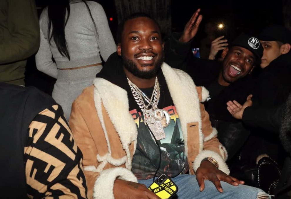 Meek Mill smiling while sitting in crowd