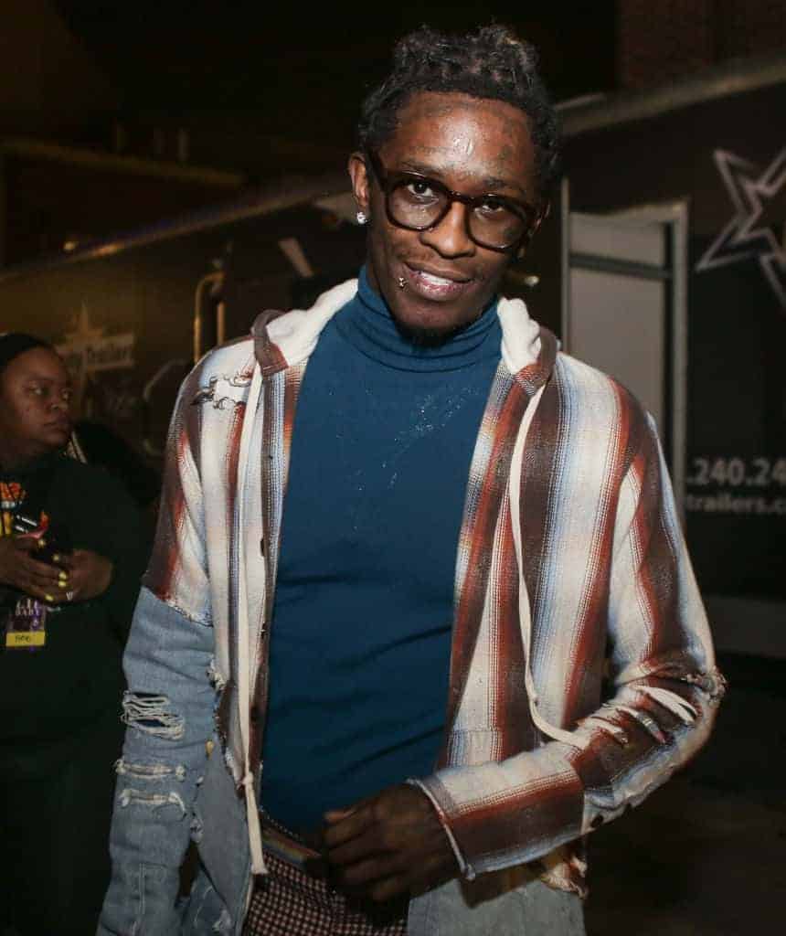 Young Thug wearing a green turtleneck and plaid shirt