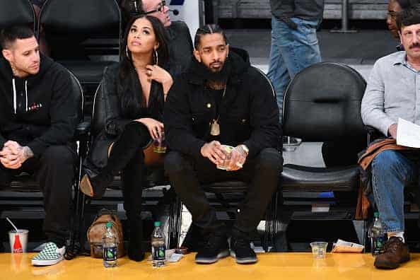 Nipsey Hussle and Lauren London attend a basketball game between the Los Angeles Lakers and the Portland Trail Blazers at Staple