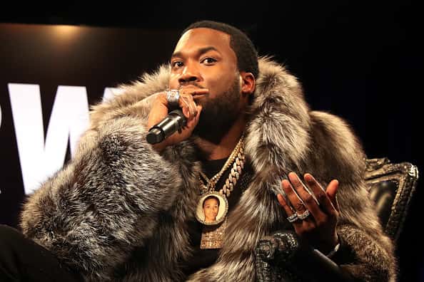 Meek Mill performing in fur coat