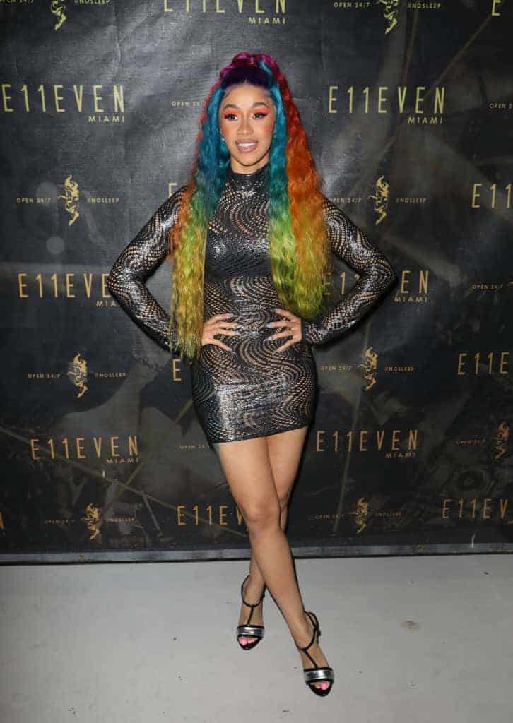Cardi B wearing rainbow colored hair and a black dress