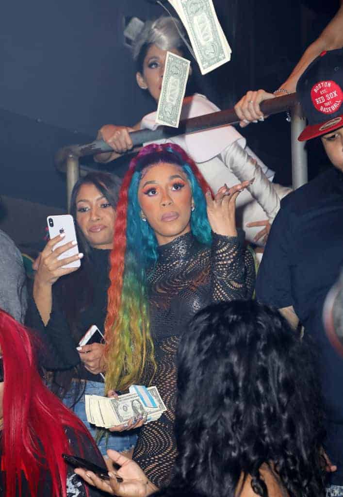 Cardi B with rainbow hair throwing money