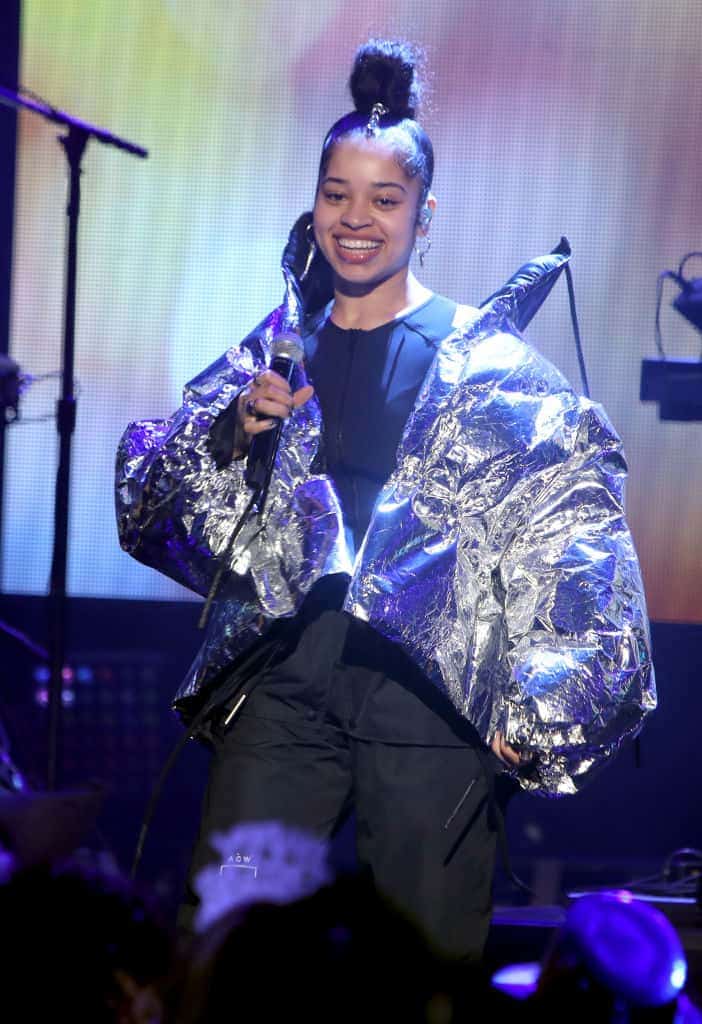 Ella Mae wearing a big jacket on stage