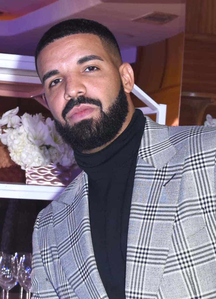 Drake wearing black turtleneck and grey blazer