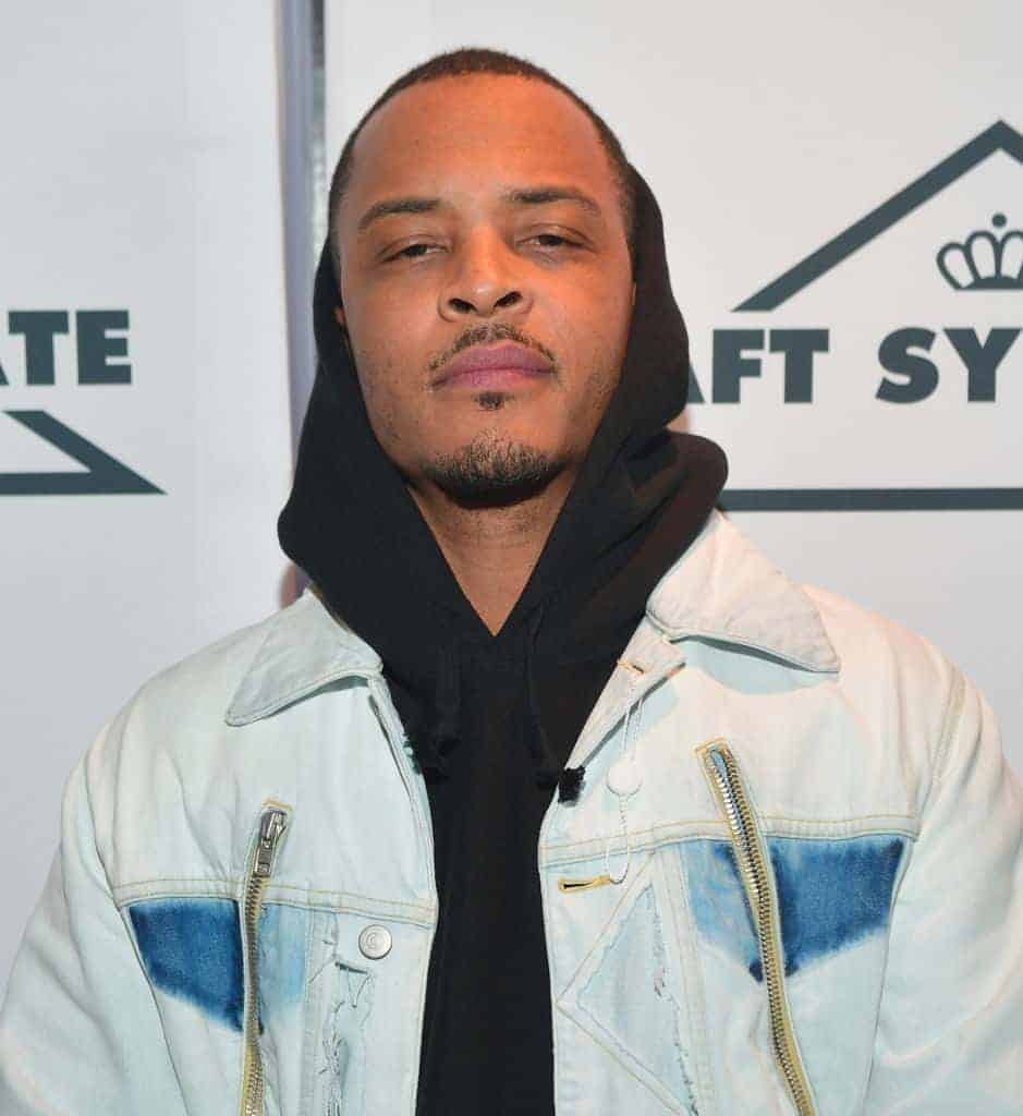T.I. wearing a blue jacket and black hoodie