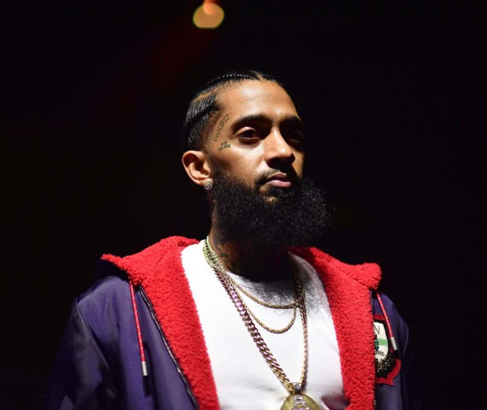 Nipsey Hussle wearing white and red and purple