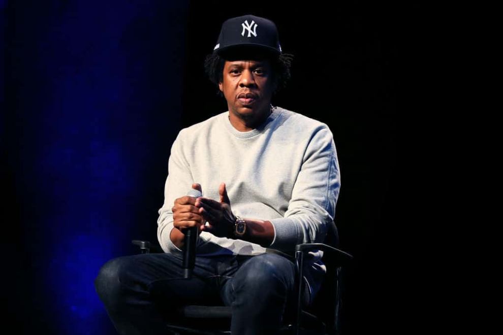 Jay-Z wearing a grey shirt