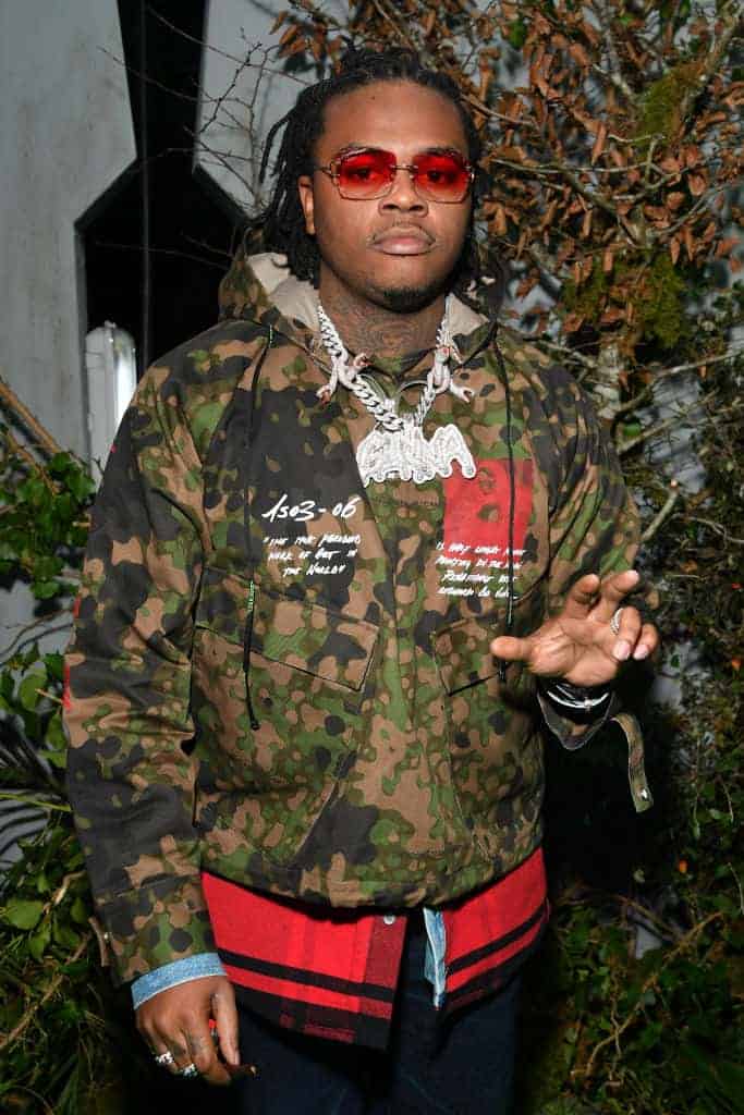 Gunna wearing a camouflage jacket and red sunglasses