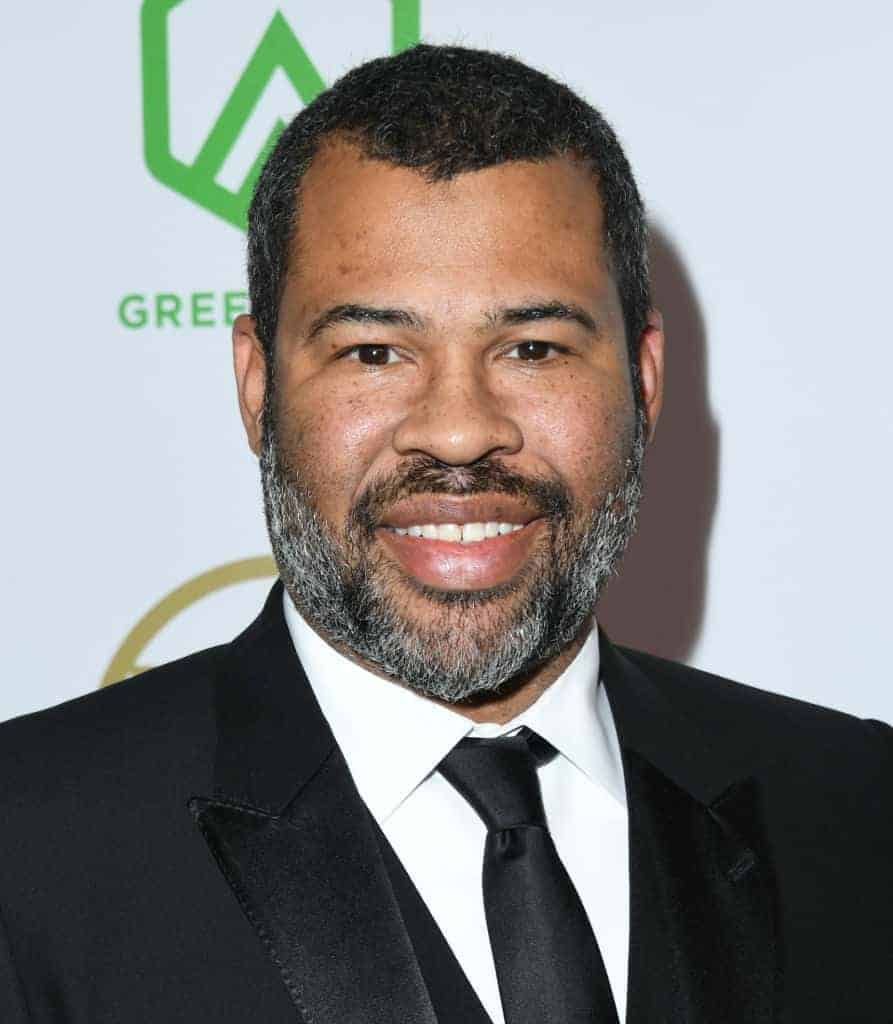 Jordan Peele wearing a black and white suit