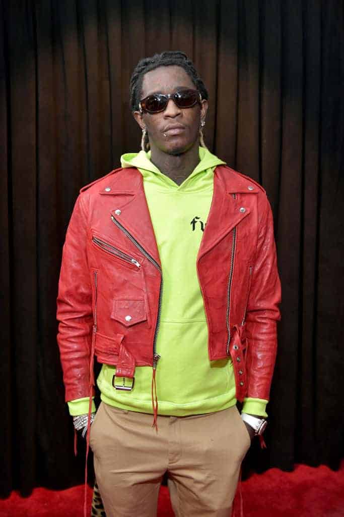 Young Thug wearing a red jacket and Green sweater