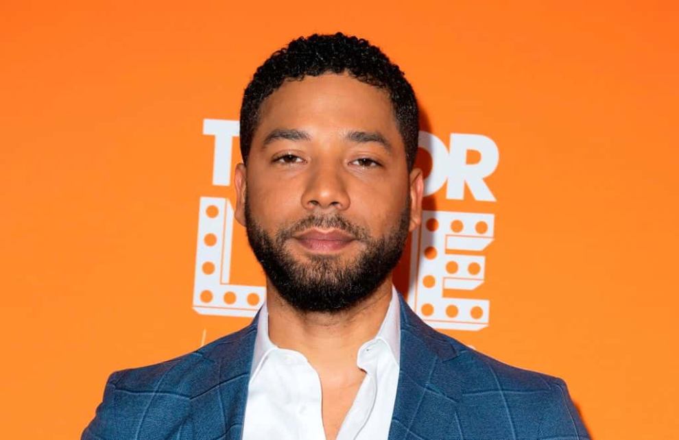 Jussie Smollett in front of an orange background