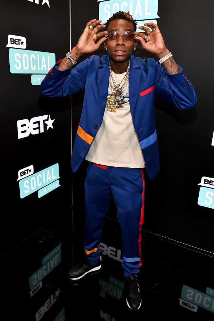 Soulja Boy wearing blue and wearing sunglasses