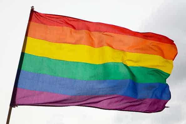 Protesters hold signs and chant slogans at a rally and march against racism and police brutality organized by leaders of black LGBTQ rights groups and attended by a large LGBTQ+ community and supporters