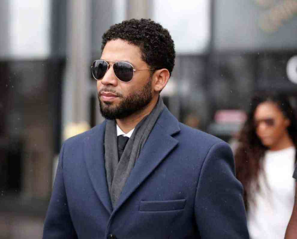 Jussie Smollett wearing suit and glasses