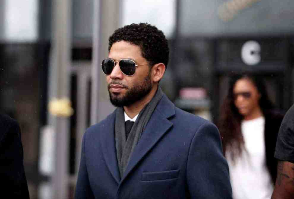 Jussie Smollett wearing suit and glasses