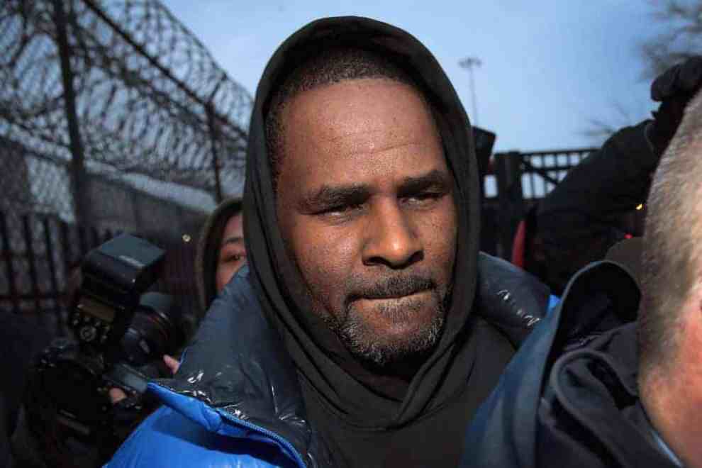 R.Kelly wearing blue jacket and black hoodie