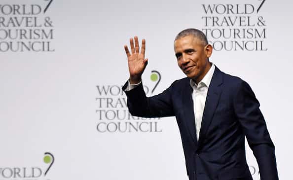 U.S. former president Barack Obama waves as he takes part in the World Travel & Tourism Council forum in Seville on April 3