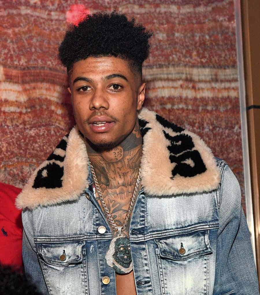 Rapper Blueface wearing a jean blue jacket facing the camera