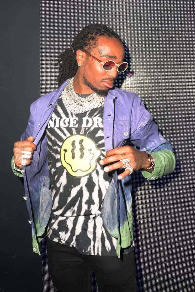 Quavo wearing purple and green jacket