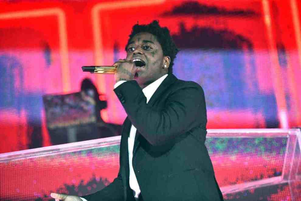 Kodak Black on stage with a microphone in his hand