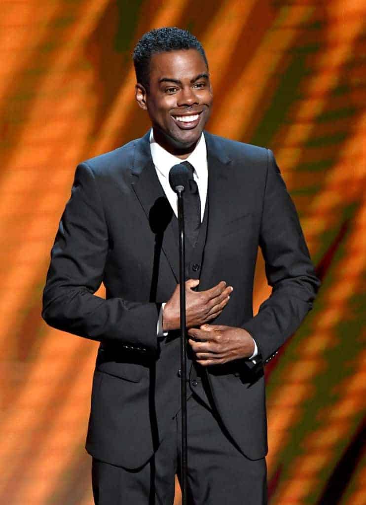 Chris Rock wearing an all black tuxedo