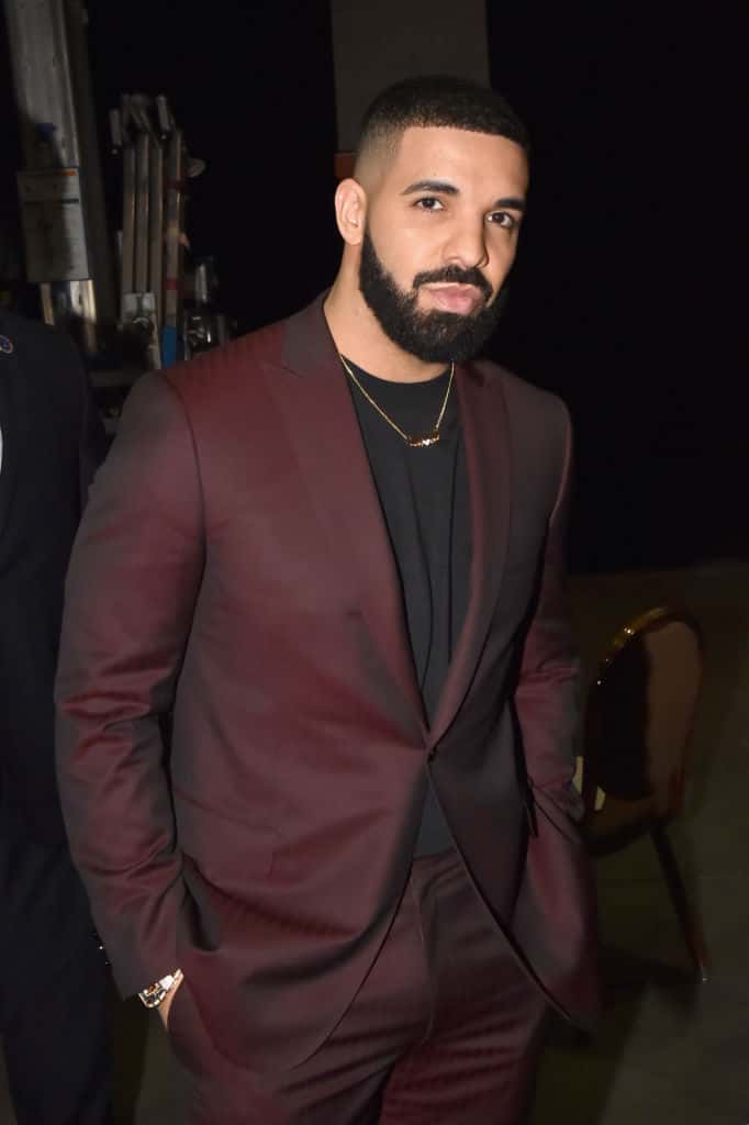 Drake wearing a burgundy suit