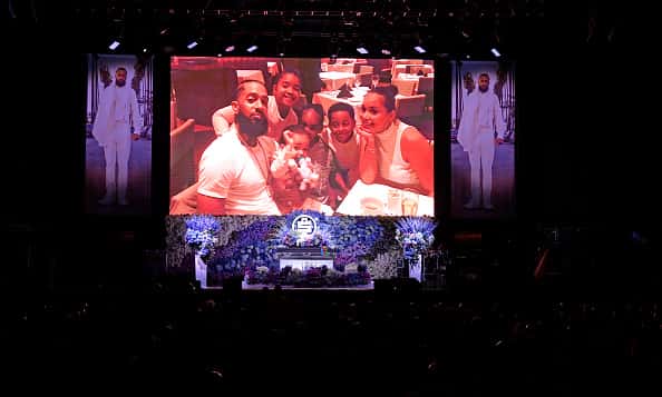Photos are displayed during Nipsey Hussle's Celebration of Life at STAPLES Center on April 11