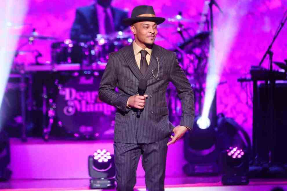 T.I wearing a brown suit and hat