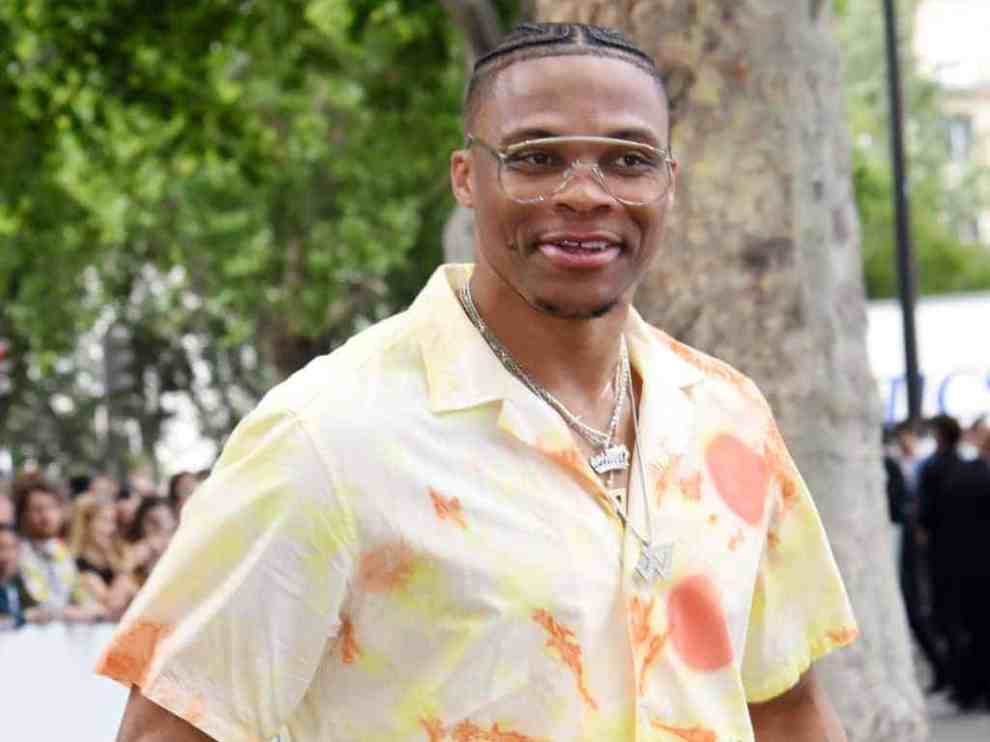 Russell Westbrook wearing an orange shirt
