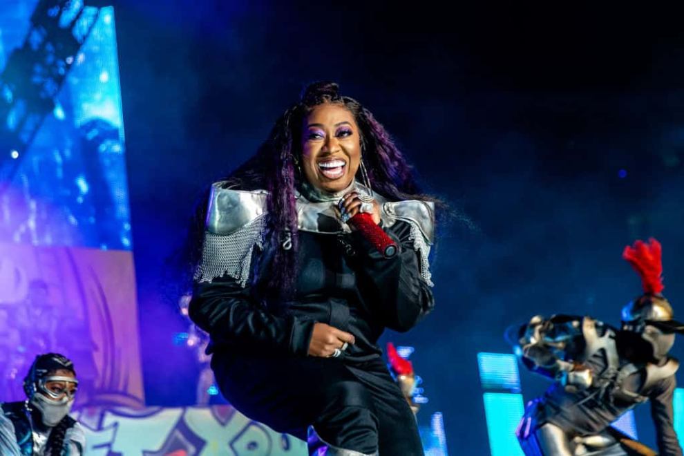 Missy Elliott wearing black on stage and performing
