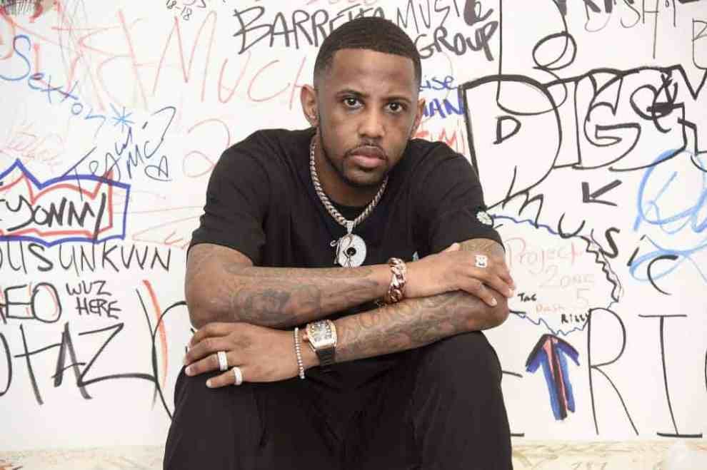Fabolous sitting in front of a colorful wall
