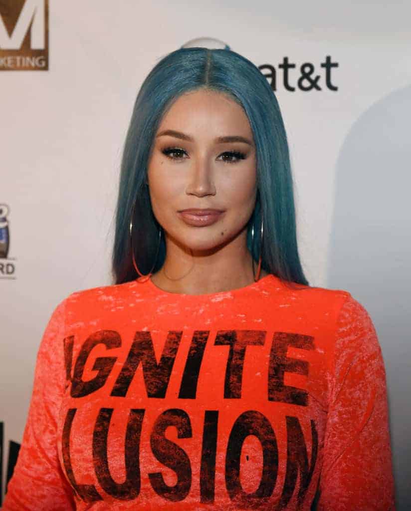 Iggy Azalea wearing an orange dress