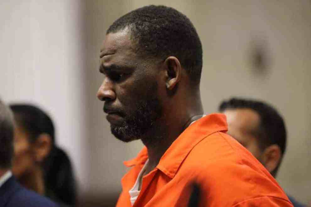 R.Kelly wearing an orange jumpsuit