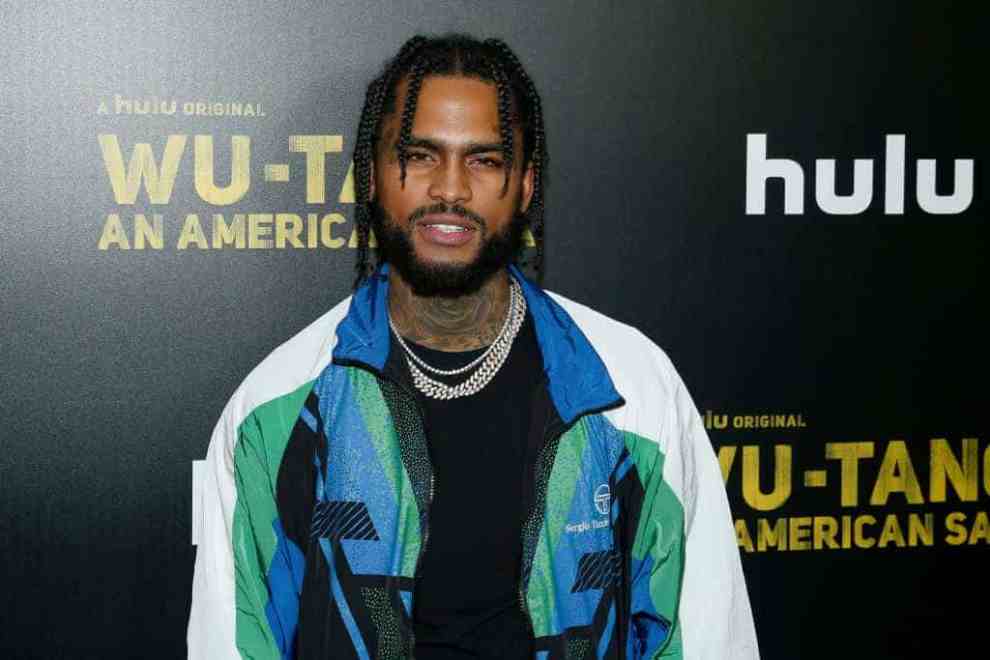 Dave East wearing a multi-colored jacket