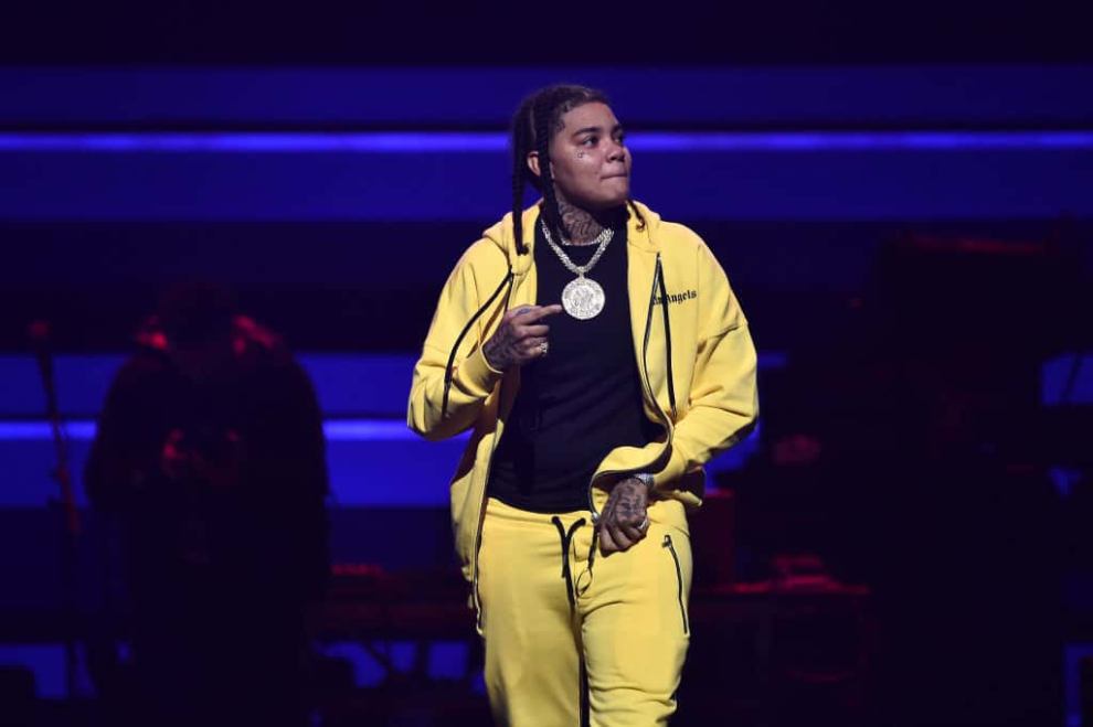 Young M.A wearing black and yellow