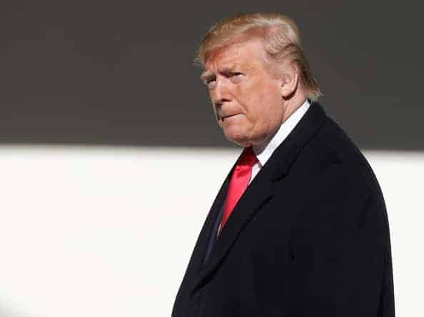 U.S. President Donald Trump walks along the colonnade after greeting Turkish President Recep Tayyip Erdogan upon his arrival at