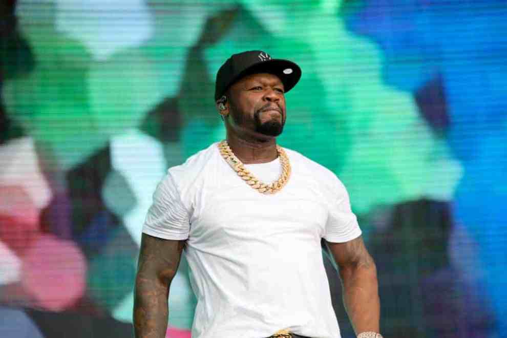 50 cent wearing a white tee on stage
