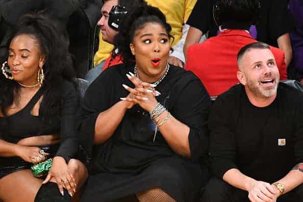 Singer Lizzo (C) attends a basketball game between the Los Angeles Laker