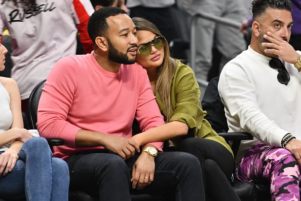 John Legend and Chrissy Teigen attend a basketball game between the Los Angeles Clippers and the Los Angeles Lakers at Staples Center on March 08