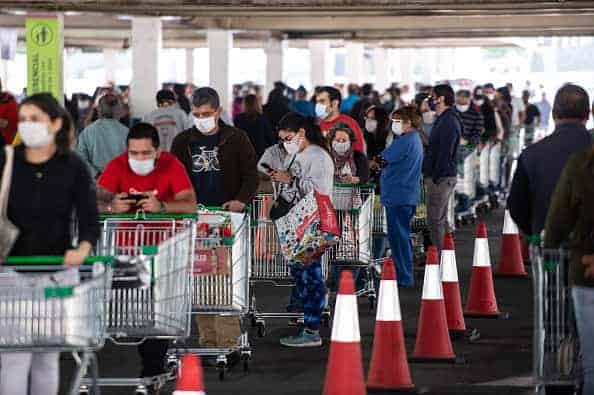 People wait in line to enter a supermarket on May 13