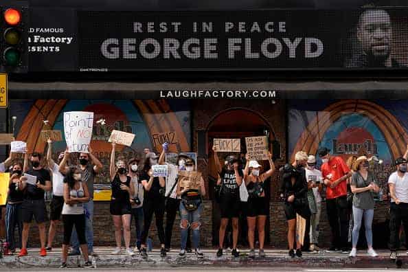 People demonstrate outside a comedy lounge on Sunset Blvd